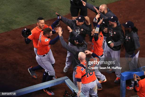 George Springer of the Houston Astros celebrates with teammates after hitting a two-run home run during the second inning against the Los Angeles...