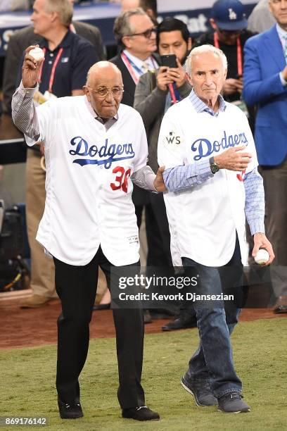 Former Los Angeles Dodgers players Don Newcombe and Sandy Koufax walk onto the field to throw out the ceremonial first pitch before game seven of the...