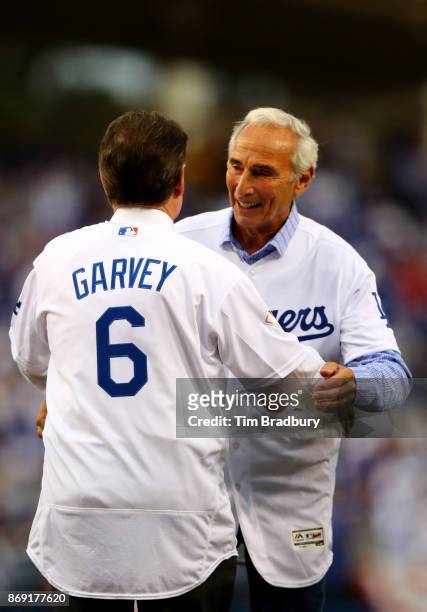 Former Los Angeles Dodgers players Sandy Koufax and Steve Garvey on the field for the ceremonial first pitch before game seven of the 2017 World...