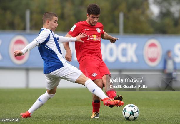 Leipzig forward Elias Abouchabaka from Germany with FC Porto forward Paulo Estrela in action during the UEFA Youth League match between FC Porto and...