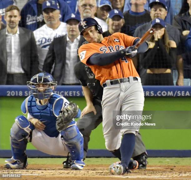 George Springer of the Houston Astros hits a two-run homer in the second inning in Game 7 of the World Series against the Los Angeles Dodgers at...