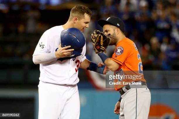 Joc Pederson of the Los Angeles Dodgers talks with Jose Altuve of the Houston Astros at second base during the sixth inning in game seven of the 2017...