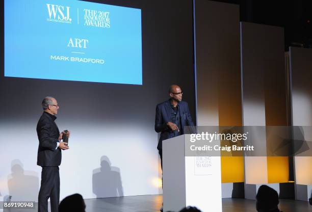 Director of MoMA Glenn Lowry presents an award onstage to artist Mark Bradford during the WSJ. Magazine 2017 Innovator Awards at MOMA on November 1,...