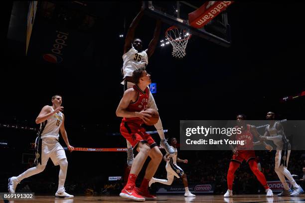Jakob Poeltl of the Toronto Raptors handles the ball against the Denver Nuggets on November 1, 2017 at the Pepsi Center in Denver, Colorado. NOTE TO...
