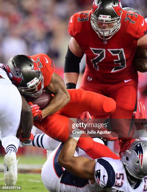 Running back Doug Martin of the Tampa Bay Buccaneers looks for yardage against the New England Patriots on October 5, 2017 at Raymond James Stadium...