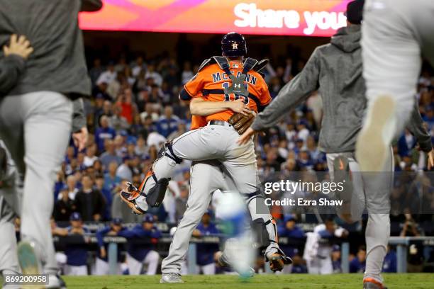 Charlie Morton and Brian McCann of the Houston Astros celebrate after defeating the Los Angeles Dodgers in game seven with a score of 5 to 1 to win...