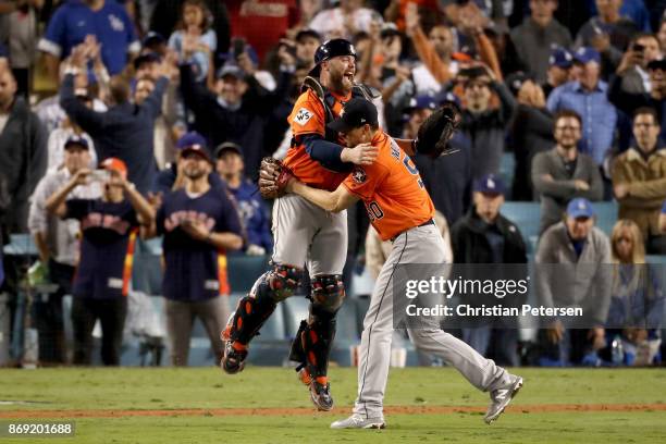 Brian McCann and Charlie Morton of the Houston Astros celebrate after defeating the Los Angeles Dodgers in game seven with a score of 5 to 1 to win...