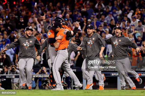 Brian McCann and Charlie Morton of the Houston Astros celebrate with teammates after defeating the Los Angeles Dodgers in game seven with a score of...