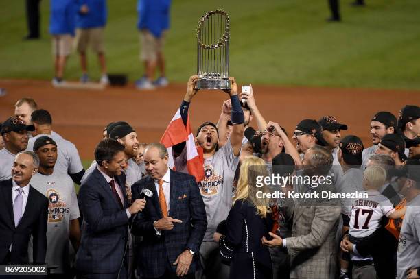 Carlos Correa of the Houston Astros hoists the Commissioner's Trophy after defeating the Los Angeles Dodgers 5-1 in game seven to win the 2017 World...