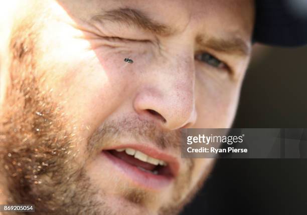 Fly is seen on the face Mark Stoneman of England as he speaks to the media during an England nets session at Richardson Park on November 2, 2017 in...
