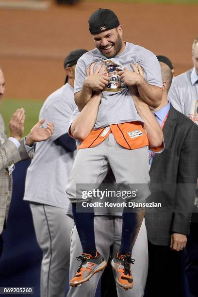 Jose Altuve of the Houston Astros celebrates with teammates after defeating the Los Angeles Dodgers 5-1 in game seven to win the 2017 World Series at...