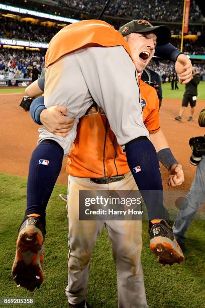 Alex Bregman and Jose Altuve of the Houston Astros celebrate after defeating the Los Angeles Dodgers 5-1 in game seven to win the 2017 World Series...