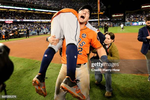 Alex Bregman and Jose Altuve of the Houston Astros celebrate after defeating the Los Angeles Dodgers 5-1 in game seven to win the 2017 World Series...