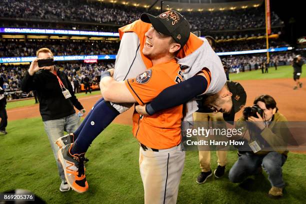 Alex Bregman and Jose Altuve of the Houston Astros celebrate after defeating the Los Angeles Dodgers 5-1 in game seven to win the 2017 World Series...
