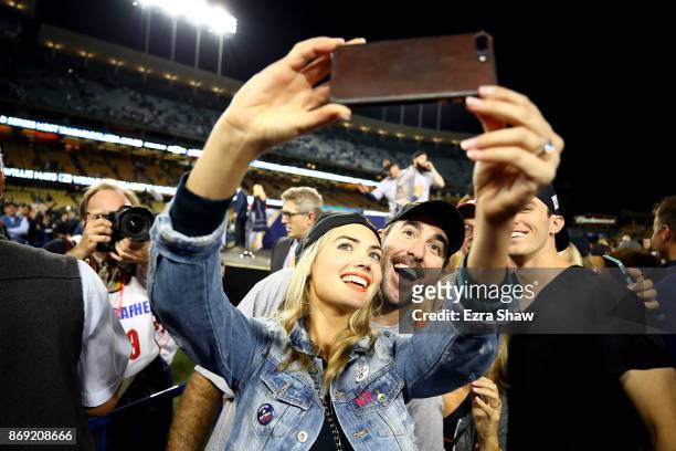 Justin Verlander of the Houston Astros takes a picture with fiancee Kate Upton after the Astros defeated the Los Angeles Dodgers 5-1 in game seven to...