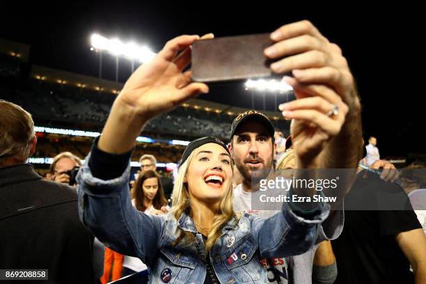 Justin Verlander of the Houston Astros takes a picture with fiancee Kate Upton after the Astros defeated the Los Angeles Dodgers 5-1 in game seven to...