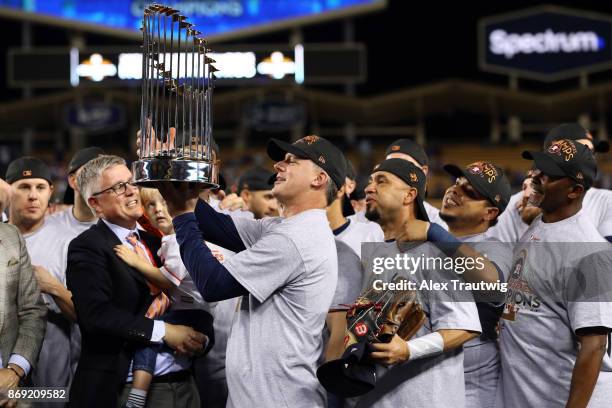 Manager A.J. Hinch of the Houston Astros lifts the Commissioner's Trophy after the Astros defeated the Los Angeles Dodgers in Game 7 of the 2017...