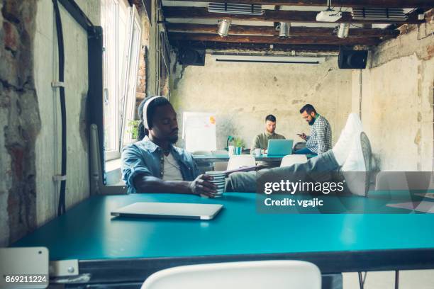 african man podcasting - electronic listening device stock pictures, royalty-free photos & images