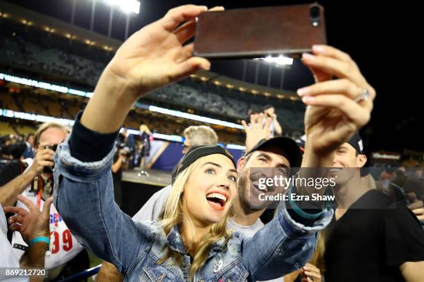 Justin Verlander of the Houston Astros takes a picture with fiancee Kate Upton after the Astros defeated the Los Angeles Dodgers 5-1 in game seven to...