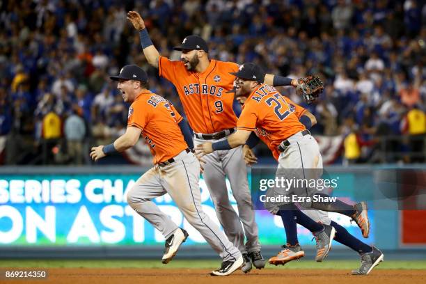 Alex Bregman, Marwin Gonzalez, Carlos Correa, and Jose Altuve of the Houston Astros celebrate defeating the Los Angeles Dodgers 5-1 in game seven to...