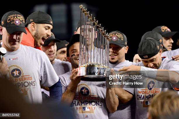 Jose Altuve of the Houston Astros holds the Commissioner's Trophy after defeating the Los Angeles Dodgers 5-1 in game seven to win the 2017 World...