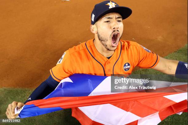 Carlos Correa of the Houston Astros celebrates on the field after the Astros defeated the Los Angeles Dodgers in Game 7 of the 2017 World Series at...