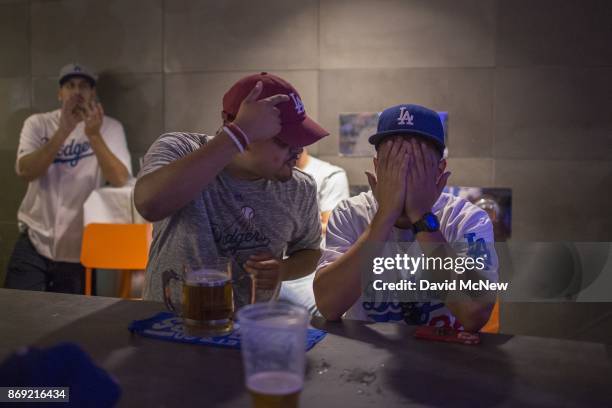 Los Angeles Dodgers fans react as the Houston Astros dominate the Los Angeles Dodgers in the final game of the World Series to take the championship...