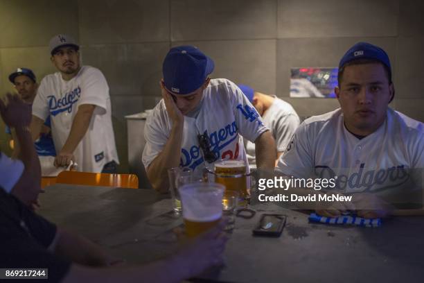 Los Angeles Dodgers fans react as the Houston Astros dominate the Los Angeles Dodgers in the final game of the World Series to take the championship...
