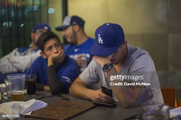 Los Angeles Dodgers fans react as the Houston Astros dominate the Los Angeles Dodgers in the final game of the World Series to take the championship...