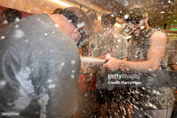 Dallas Keuchel of the Houston Astros celebrates with teammates in the clubhouse after defeating the Los Angeles Dodgers 5-1 in game seven to win the...