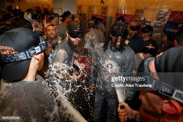 Cameron Maybin and Dallas Keuchel of the Houston Astros celebrate in the clubhouse after the Astros defeated the Los Angeles Dogdgers in Game 7 of...