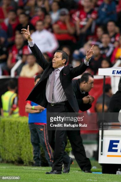 Jose Guadalupe Cruz coach of Atlas gives instructions to his players during the 8th round match between Atlas and Tigres UANL as part of the Torneo...