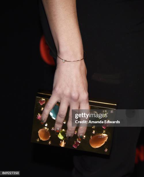 Singer-songwriter Bonnie McKee, clutch detail, arrives at Spotify's Inaugural Secret Genius Awards on November 1, 2017 in Los Angeles, California.