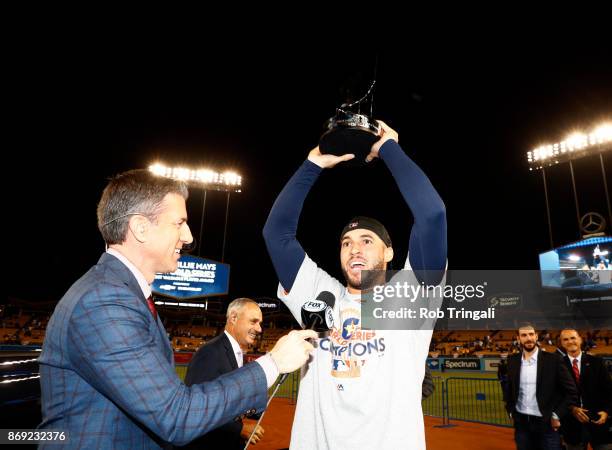 Kevin Burhardt of FOX interviews 2017 Willie Mays World Series MVP George Springer of the Houston Astros after he is presented with the MVP trophy...