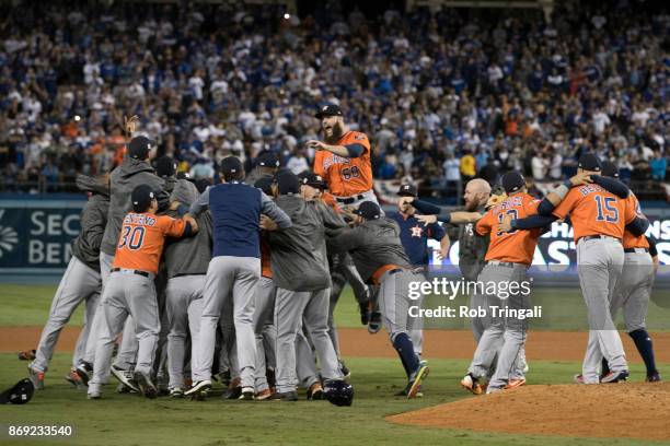 Members of the Houston Astros celebrate on the field after the Astros defeated the Los Angeles Dodgers in Game 7 of the 2017 World Series at Dodger...