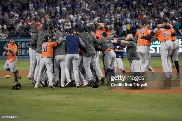 Members of the Houston Astros celebrate on the field after the Astros defeated the Los Angeles Dodgers in Game 7 of the 2017 World Series at Dodger...