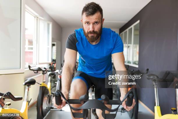 exercising class - spin instructor stock pictures, royalty-free photos & images