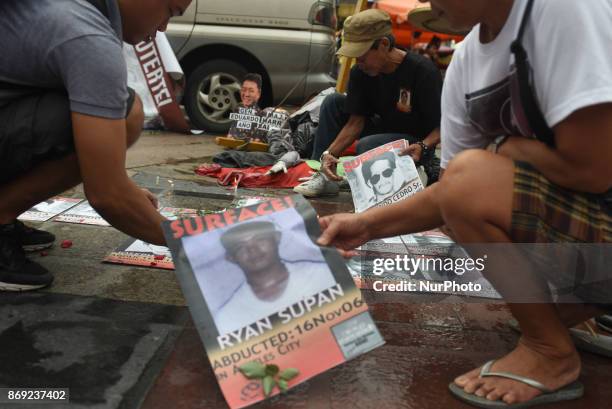 Families of the desaparecidos from alleged extra judicial killings from different administrations conduct a protest at the Plaza Miranda in Quiapo,...