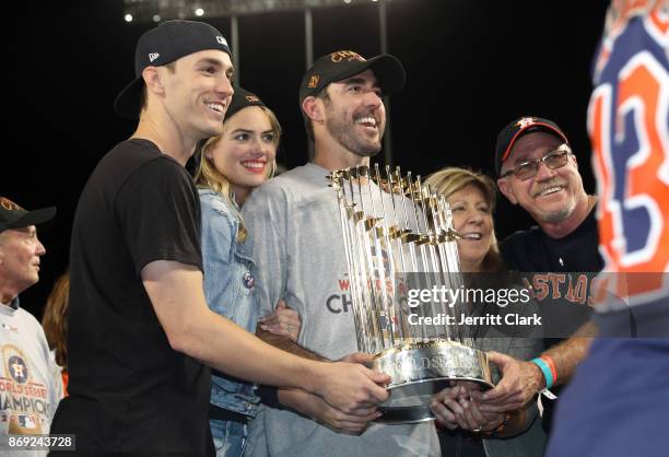 Kate Upton poses for a photo with boyrfriend Justin Verlander of the Houston Astros holding the The Commissioner's Trophy after the conclusion of The...