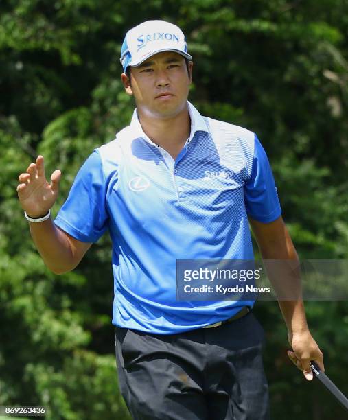 Japanese golfer Hideki Matsuyama reacts to cheers from spectators in August 2017, after carding a birdie on the eighth hole in the first round of the...