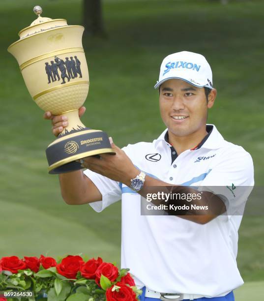 Japanese golfer Hideki Matsuyama poses with his trophy after winning the WGC-Bridgestone Invitational in Akron, Ohio in August 2017. Matsuyama is...