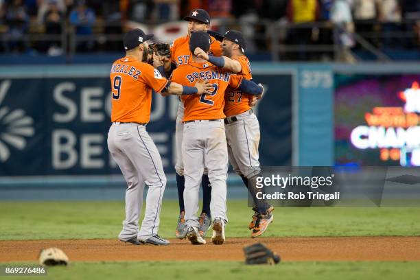 Jose Altuve and Carlos Correa, Marwin Gonzalez and Alex Bregman of the Houston Astros celebrate on the field after the Astros defeated the Los...