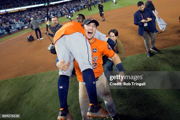 Jose Altuve and Alex Bregman of the Houston Astros celebrate on the field after the Astros defeated the Los Angeles Dodgers in Game 7 of the 2017...