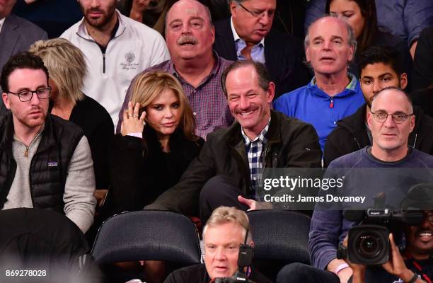 Roxana Girand and Eliot Spitzer attend the Houston Rockets Vs New York Knicks game at Madison Square Garden on November 1, 2017 in New York City.