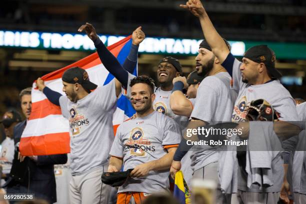 Members of the Houston Astros pose for a photo with the Commissioner's Trophy after the Astros defeated the Los Angeles Dodgers in Game 7 of the 2017...