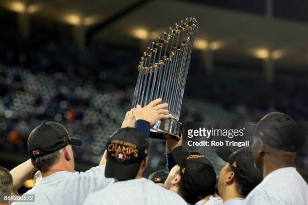 Members of the Houston Astros hoist the Commissioner's Trophy after defeating the Los Angeles Dodgers in Game 7 of the 2017 World Series at Dodger...