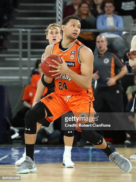 Michael Carrera of the Cairn Taipans controls the ball during the round five NBL match between Melbourne United and the Cairns Taipans at Hisense...