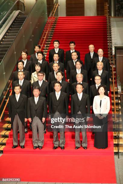 Japanese Prime Miniser Shinzo Abe and his cabinet members pose for photographs at the prime minister's official residence during the Lower House...
