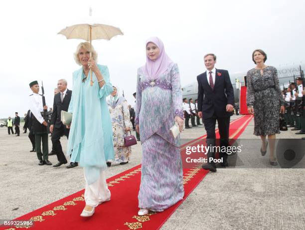 The Duchess of Cornwall is accompanied by Sarah, Crown Princess of Brunei, upon arriving in Brunei during an 11-day autumn tour of Asia on November...