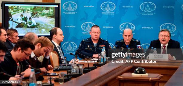 Russian Foreign Ministry's security and disarmament department head Mikhail Ulyanov along with other attendees hold a briefing to present analysis of...
